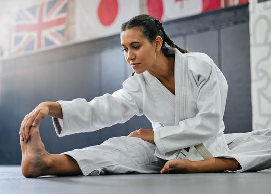 a girl wearing amas a gi stretching her body 