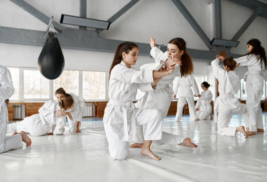 women practicing martial arts wearing amas a gi