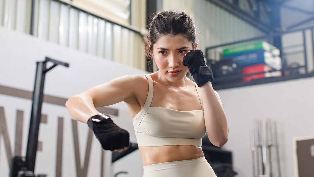 a girl wearing amas gloves practicing martial arts
